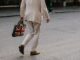 Photo of a man carrying a bag with the Union Jack flag of the UK as Prime Minister Keir Starmer unveils an AI action plan aiming to harness artificial intelligence technologies to unlock economic potential, transform public services such as the NHS, and more.